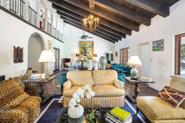 a living room with furniture fireplace and a chandelier