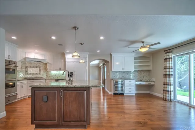 a kitchen with granite countertop stainless steel appliances and stove cabinets