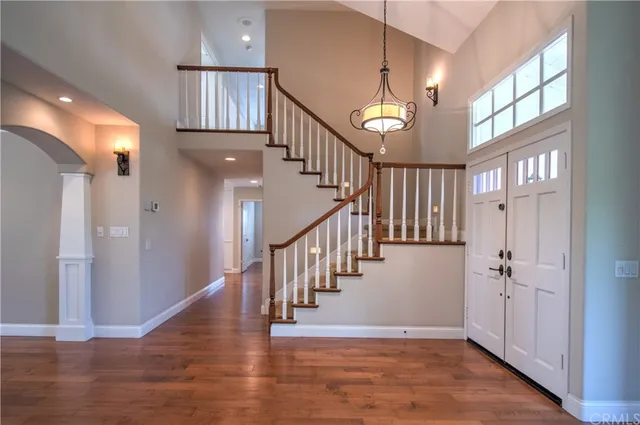 a view of entryway and hall with wooden floor