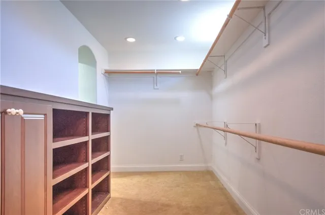 an aerial view of residential houses with outdoor space and parking