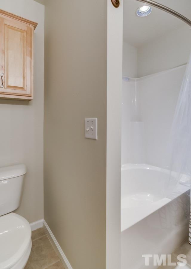 9813 Castain Drive Raleigh, NC 27617 - Photo 11 of 16 a white toilet sitting next to a bath tub