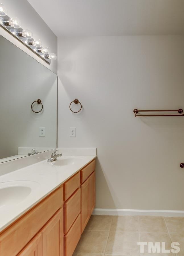 9813 Castain Drive Raleigh, NC 27617 - Photo 12 of 16 a bathroom with a sink and mirror