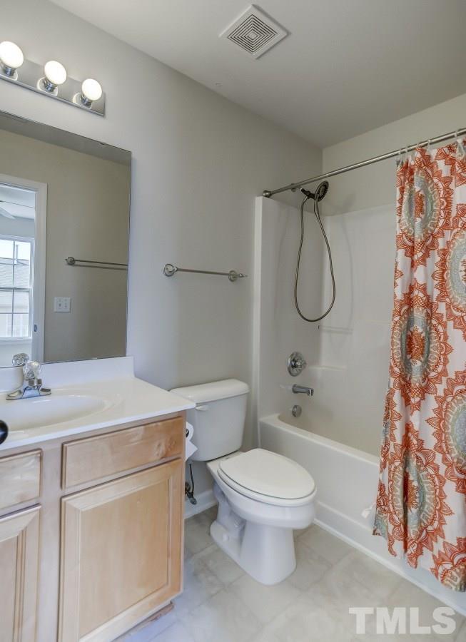 9813 Castain Drive Raleigh, NC 27617 - Photo 14 of 16 a bathroom with a sink a toilet and shower