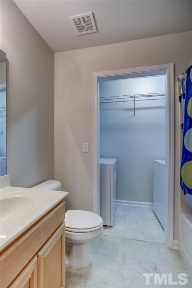 9813 Castain Drive Raleigh, NC 27617 - Photo 4 of 16 a white toilet sitting next to a bathroom sink