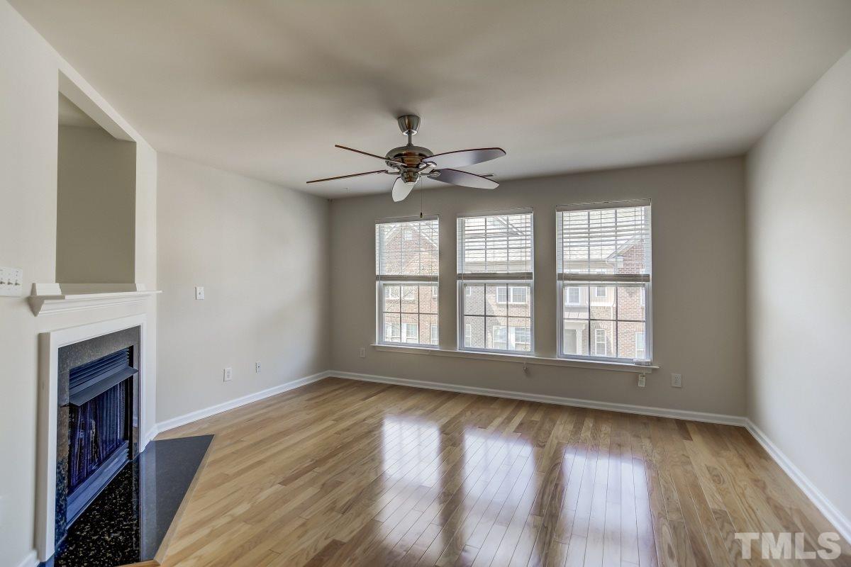 9813 Castain Drive Raleigh, NC 27617 - Photo 5 of 16 a view of an empty room with wooden floor and a window