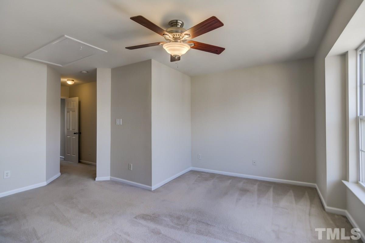 9813 Castain Drive Raleigh, NC 27617 - Photo 10 of 16 an empty room with closet and ceiling fan