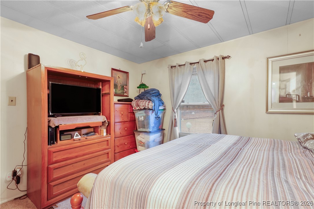 156 Connell Road Carthage, NC 28327 - Photo 15 of 43 a bedroom with a bed and a flat tv screen on dresser
