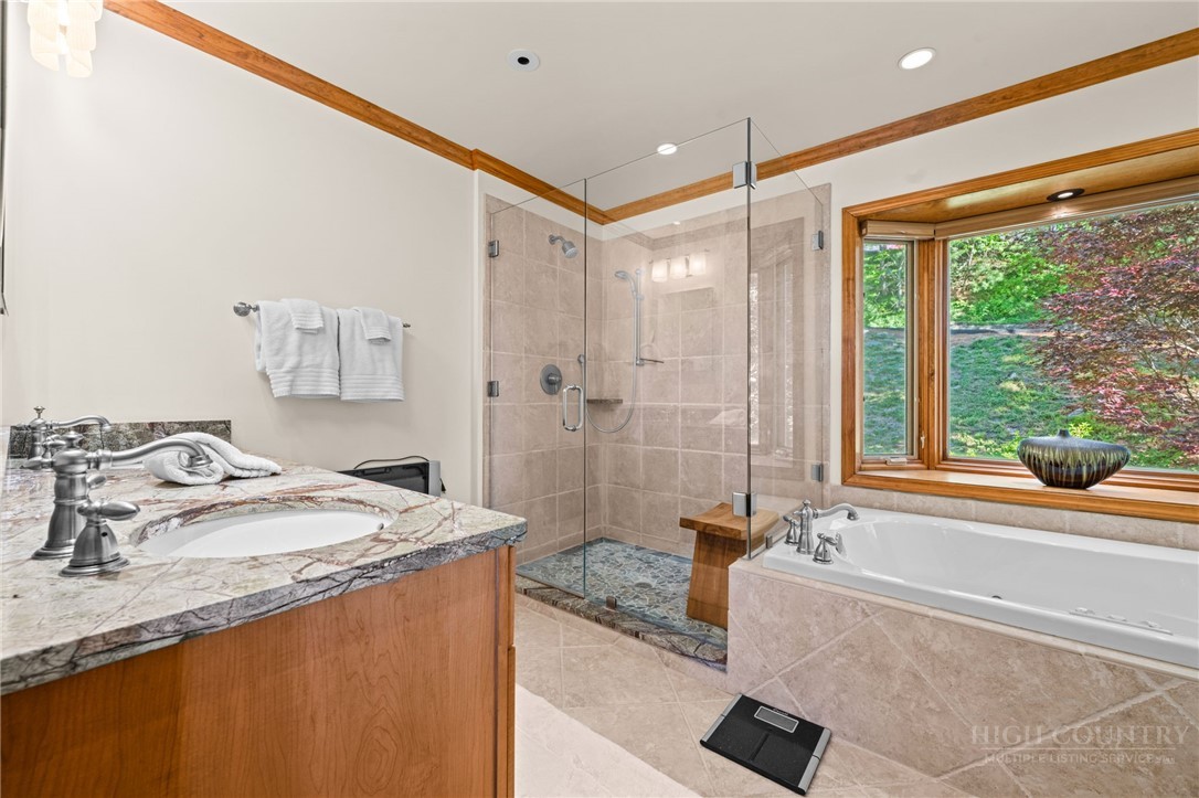 331 Alpine Road Blowing Rock, NC 28605 - Photo 28 of 50 a bathroom with a granite countertop sink and a bathtub