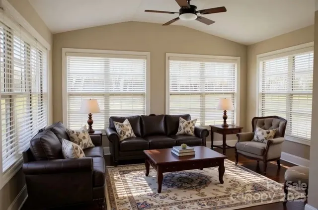 a living room with furniture a lamp and a window