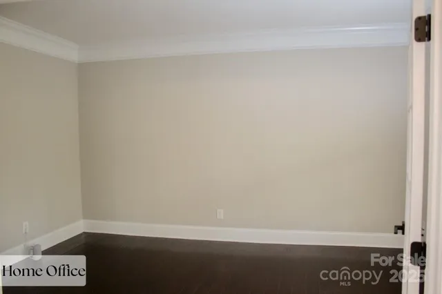 an empty room with a window and a ceiling fan