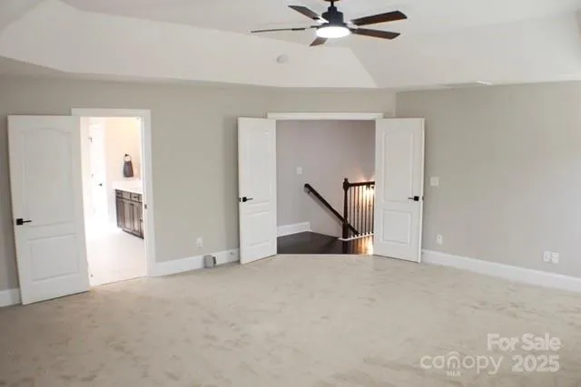 a bathroom with a granite countertop shower a toilet and a window