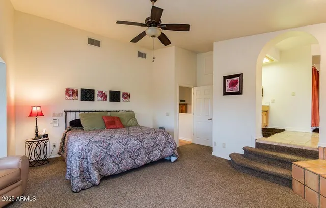 a bedroom with a bed and a chandelier