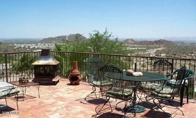 a view of a chairs and table in patio