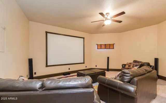 a living room with furniture and a ceiling fan