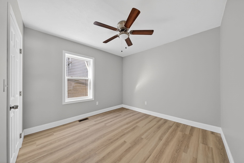169 Grant Street Fall River, MA 02721 - Photo 11 of 42 a view of wooden floor and a chandelier fan in a room