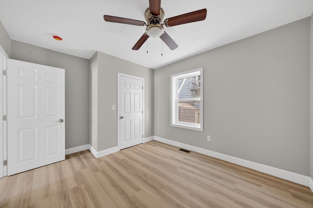 169 Grant Street Fall River, MA 02721 - Photo 12 of 42 wooden floor in an empty room with a window