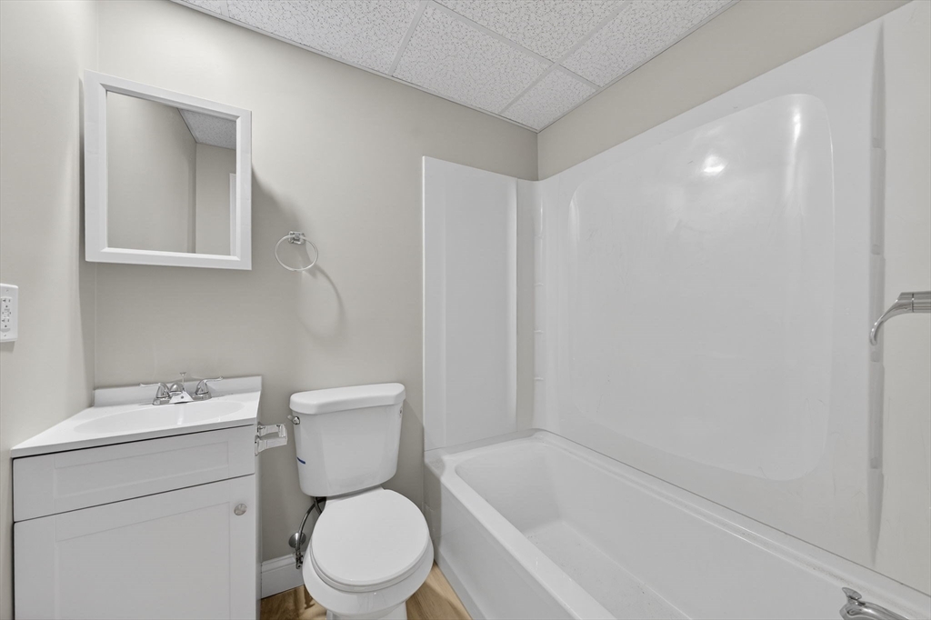 169 Grant Street Fall River, MA 02721 - Photo 25 of 42 a white toilet sitting next to a bath tub