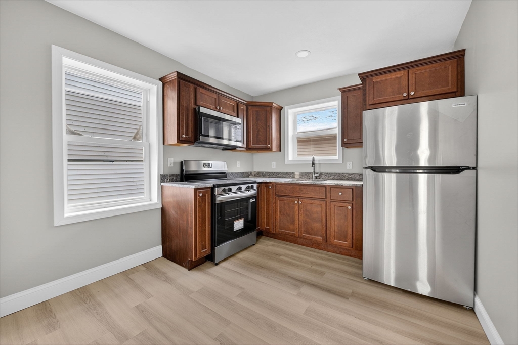 169 Grant Street Fall River, MA 02721 - Photo 26 of 42 a kitchen with stainless steel appliances granite countertop a stove a sink refrigerator and a microwave