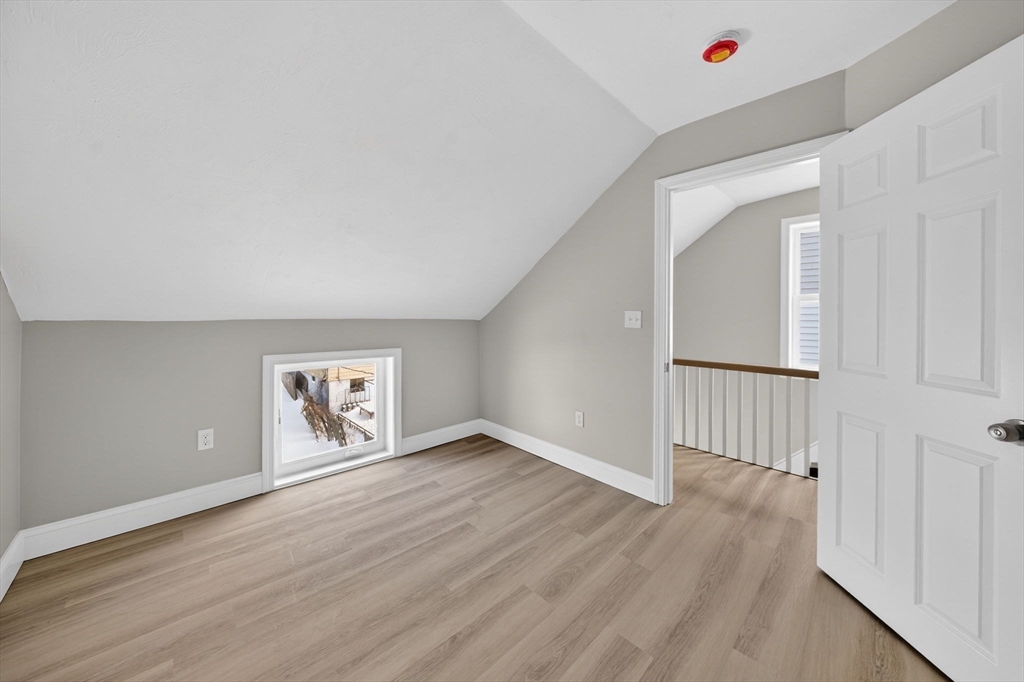 169 Grant Street Fall River, MA 02721 - Photo 33 of 42 an empty room with wooden floor and windows