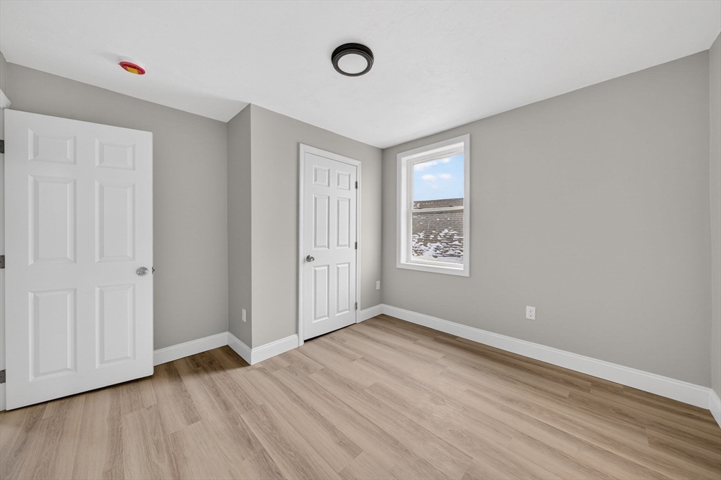 169 Grant Street Fall River, MA 02721 - Photo 37 of 42 a view of an empty room with wooden floor and a window