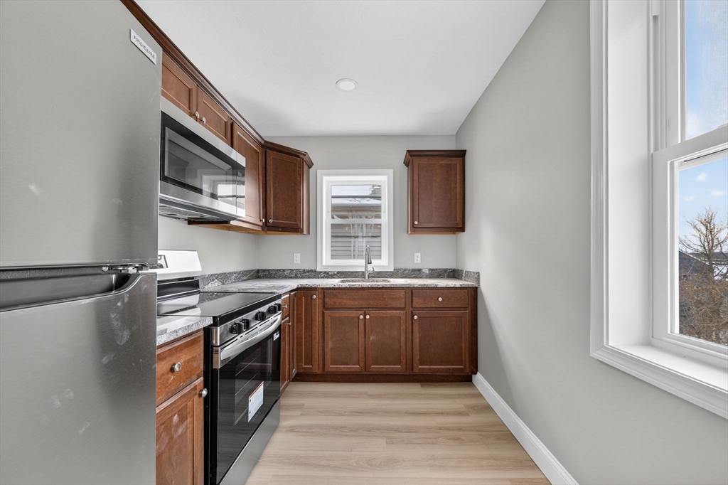 169 Grant Street Fall River, MA 02721 - Photo 39 of 42 a kitchen with stainless steel appliances granite countertop a stove top oven a sink and dishwasher