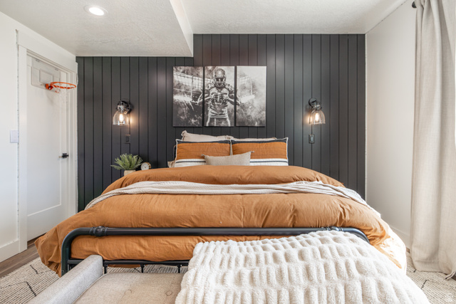 1276 West Fallow Way, Unit 76 Ogden, UT 84414 - Photo 6 of 22 Bedroom featuring wooden walls and a textured ceiling