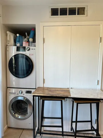 a utility room with sink dryer and washer