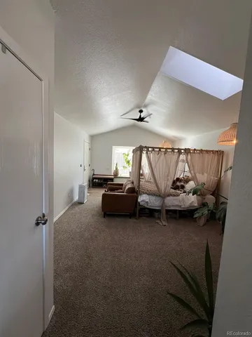 a living room with furniture and a air conditioner vent