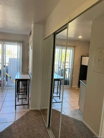 a view of a livingroom with furniture and a window