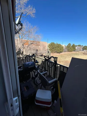 a view of a balcony with chair and wooden floor