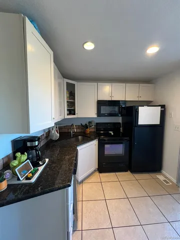 a kitchen with a sink and a stove top oven