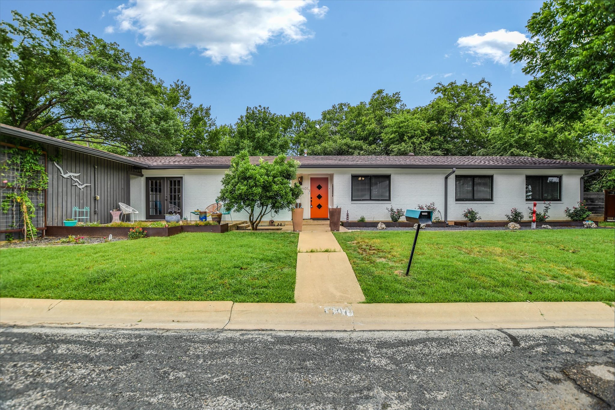 a front view of house with yard and green space