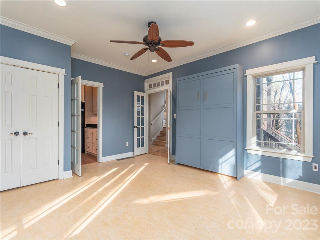 175 Red Oak Road Marshall, NC 28753 - Photo 11 of 34 a view of a livingroom with a chandelier fan and windows