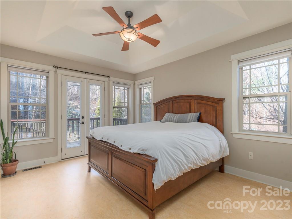 175 Red Oak Road Marshall, NC 28753 - Photo 17 of 34 a bedroom with a large bed and a large window