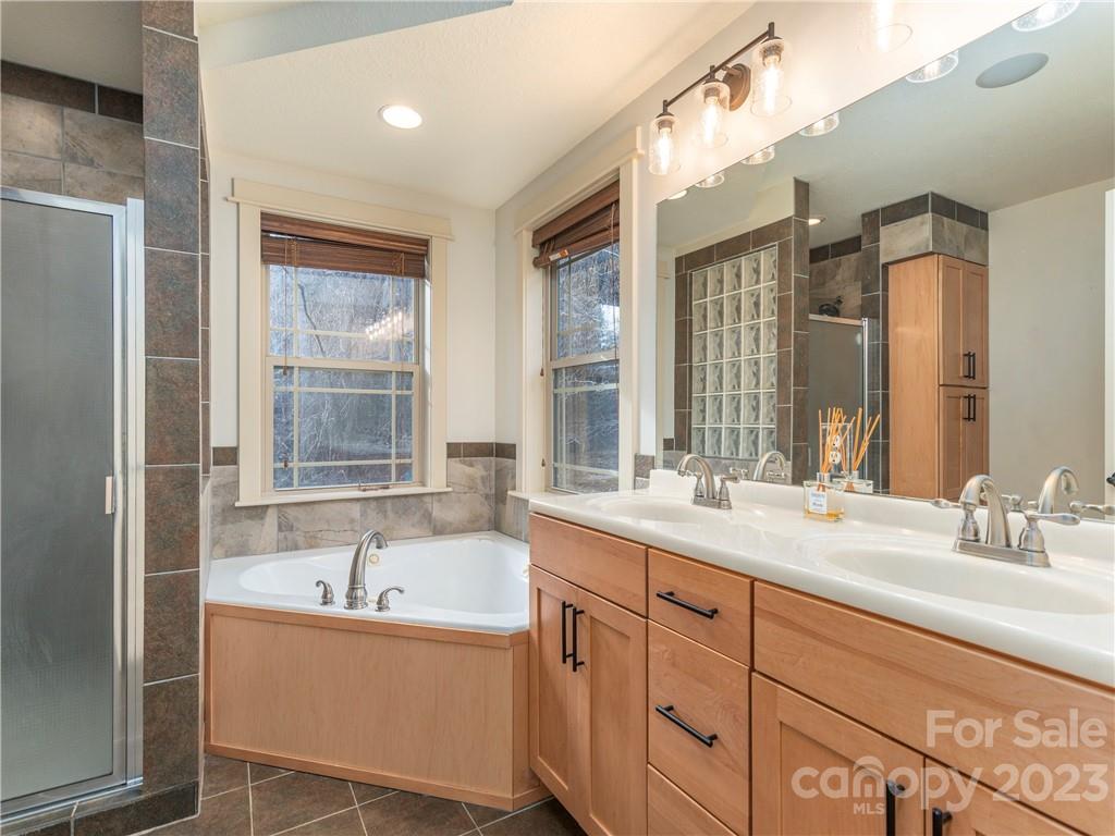 175 Red Oak Road Marshall, NC 28753 - Photo 19 of 34 a bathroom with a tub sink and mirror