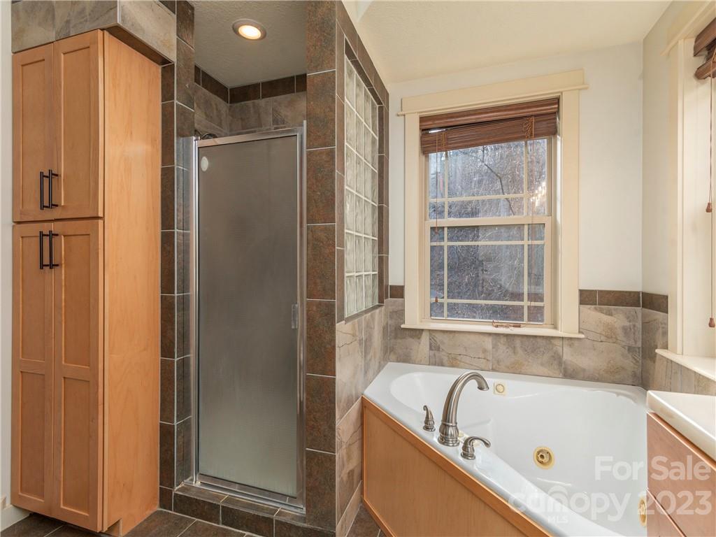 175 Red Oak Road Marshall, NC 28753 - Photo 20 of 34 a bathroom with a tub shower and a sink