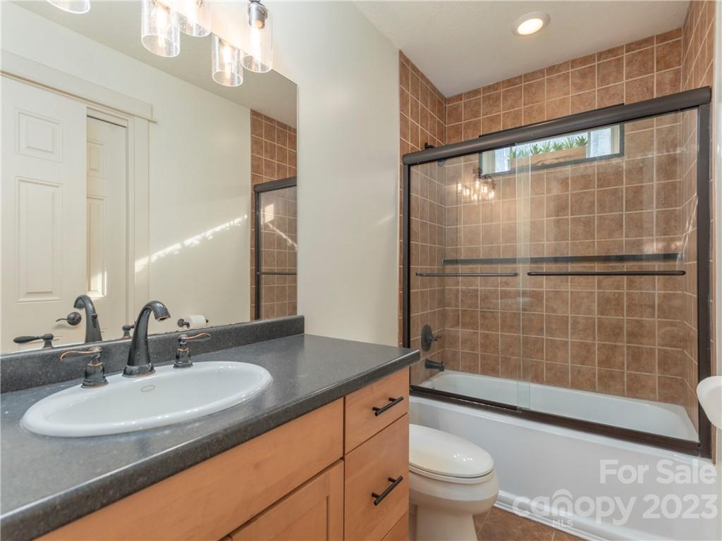 175 Red Oak Road Marshall, NC 28753 - Photo 23 of 34 a bathroom with a sink a toilet and shower