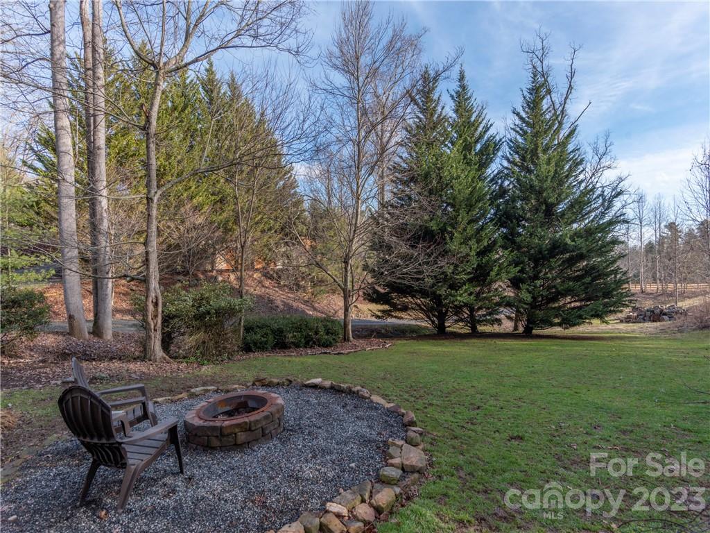 175 Red Oak Road Marshall, NC 28753 - Photo 28 of 34 a view of a backyard with table and chairs and a fire pit