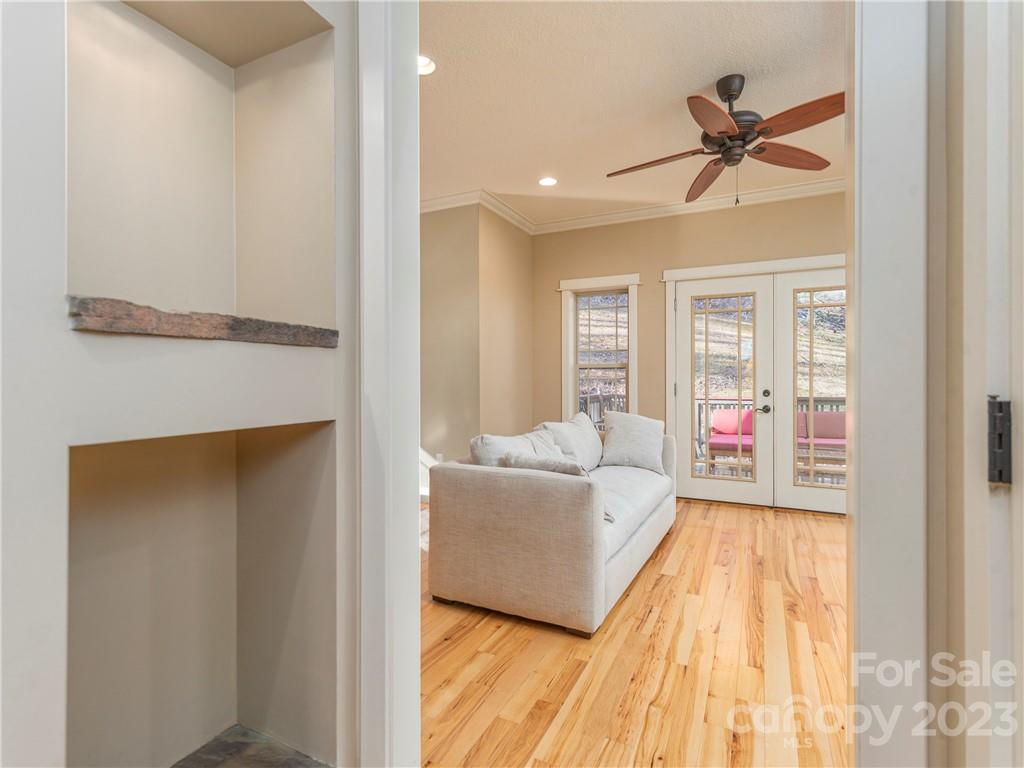175 Red Oak Road Marshall, NC 28753 - Photo 3 of 34 a living room with a bed furniture and a ceiling fan