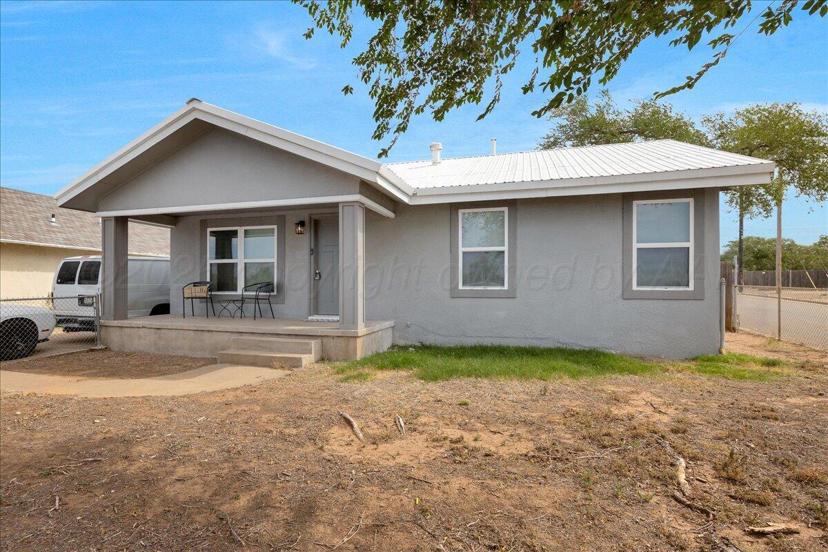 a view of a house with pool and sitting area
