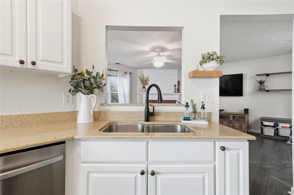 3295 Dundee Ridge Way Duluth, GA 30096 - Photo 11 of 34 a kitchen with kitchen island a sink and cabinets