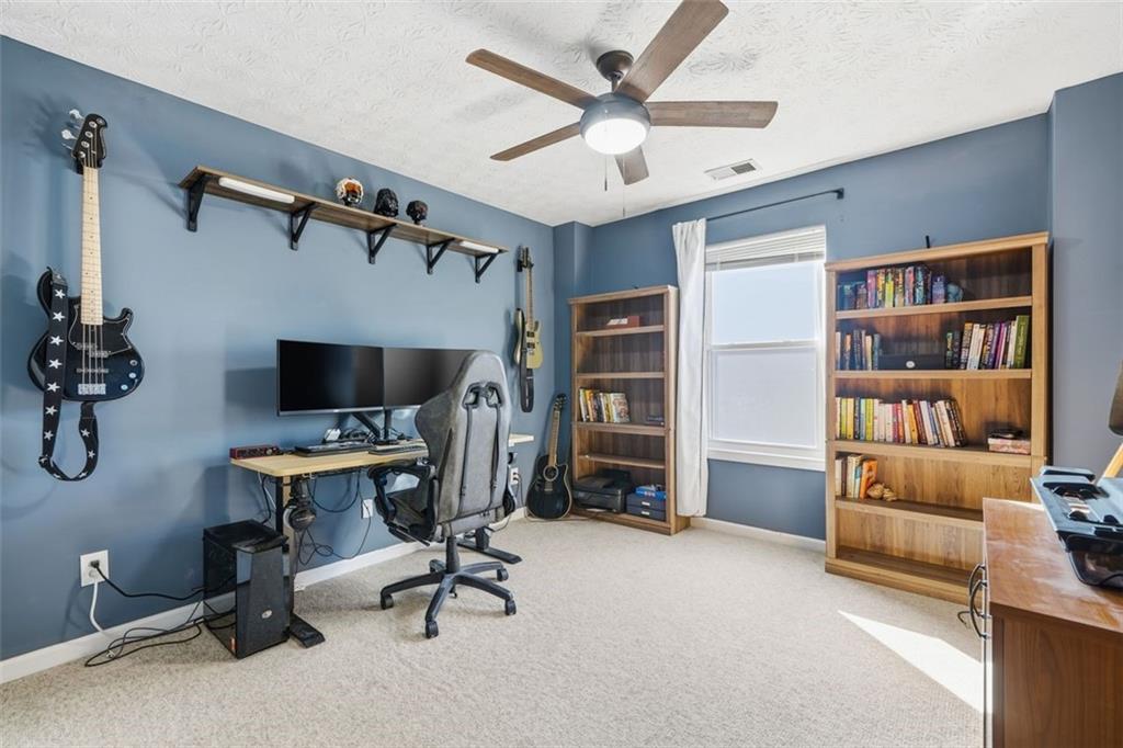 3295 Dundee Ridge Way Duluth, GA 30096 - Photo 23 of 34 a view of a livingroom with workspace and a ceiling fan