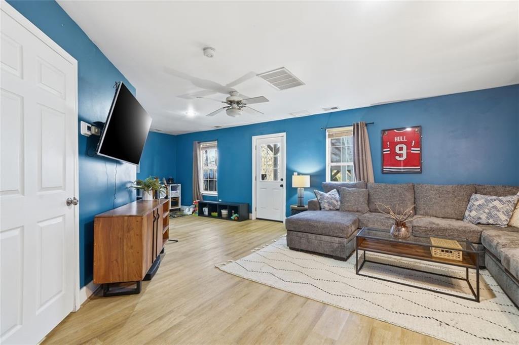 3295 Dundee Ridge Way Duluth, GA 30096 - Photo 25 of 34 a living room with furniture and a flat screen tv
