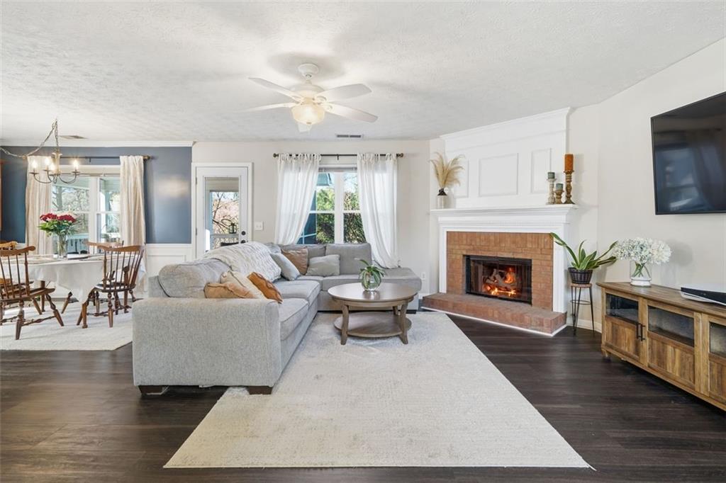 3295 Dundee Ridge Way Duluth, GA 30096 - Photo 4 of 34 a living room with furniture and a fireplace