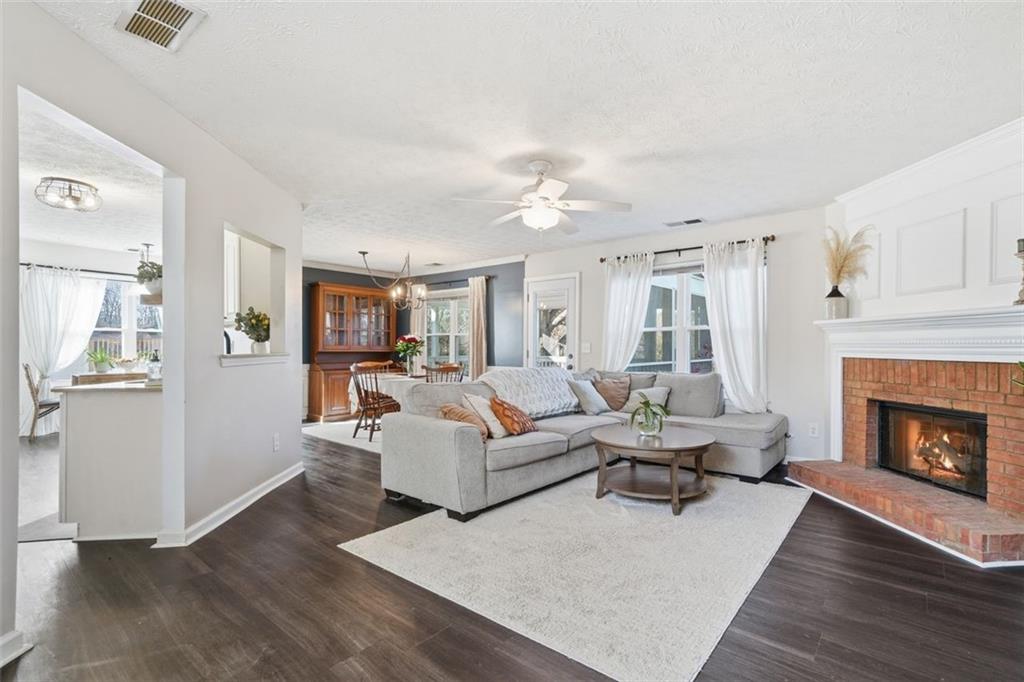 3295 Dundee Ridge Way Duluth, GA 30096 - Photo 5 of 34 a living room with furniture and a fireplace