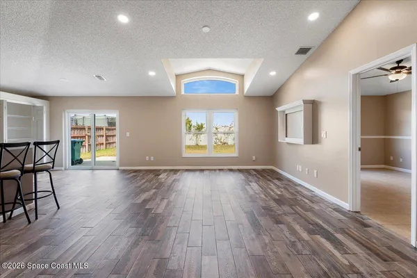 a kitchen with stainless steel appliances kitchen island granite countertop a refrigerator and microwave