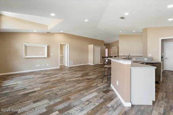 a kitchen with stainless steel appliances granite countertop a sink stove and microwave