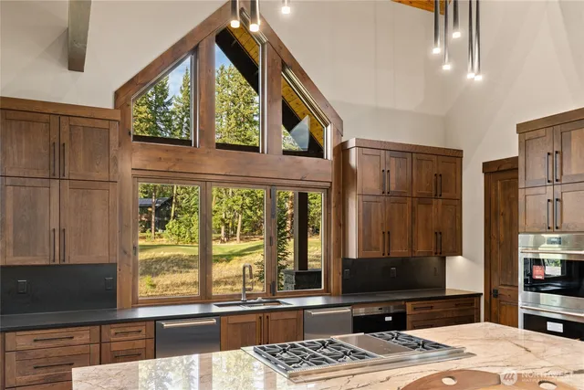 a view of a living room with furniture and floor to ceiling window