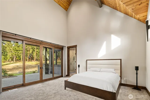 a bedroom with a large bed and a large window