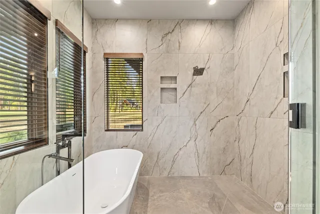 a bathroom with a bathtub and shower